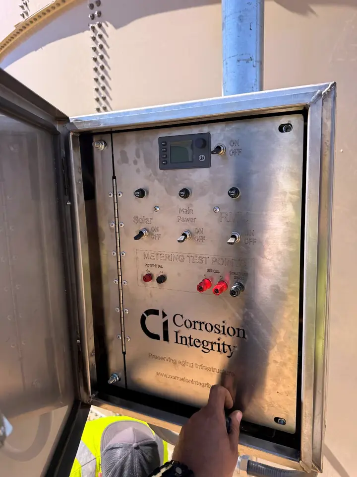 Open stainless controller cabinet showing the labelled front panel