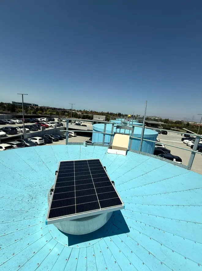 Solar module mounted on the roof of a large blue bolted steel tank
