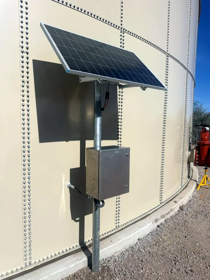 Solar module and stainless controller cabinet post-mounted on the shell of a bolted steel water tank