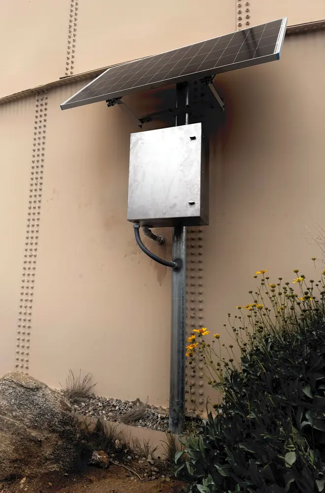 Solar module and controller cabinet post-mounted against a storage tank shell